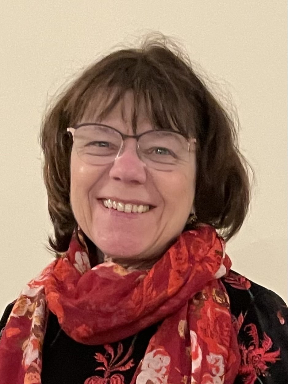 Maria Setzer Farbiges Foto Maria Setzer, Kandidatin Pfarrgemeinderatswahl 2026, St. Ulrich, Kinnlange braune Haare, Brille, rotes, gemustertes Tuch, schwarzes Shirt